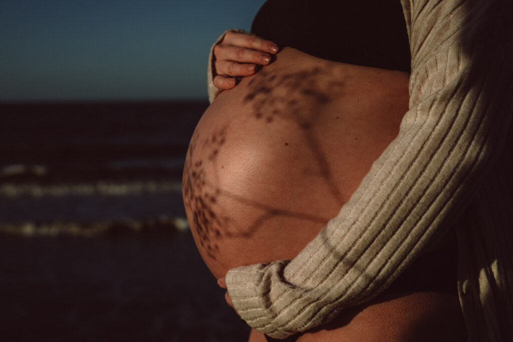 Margate Pregnancy photoshoot with pregnant bump and shadow play with foliage