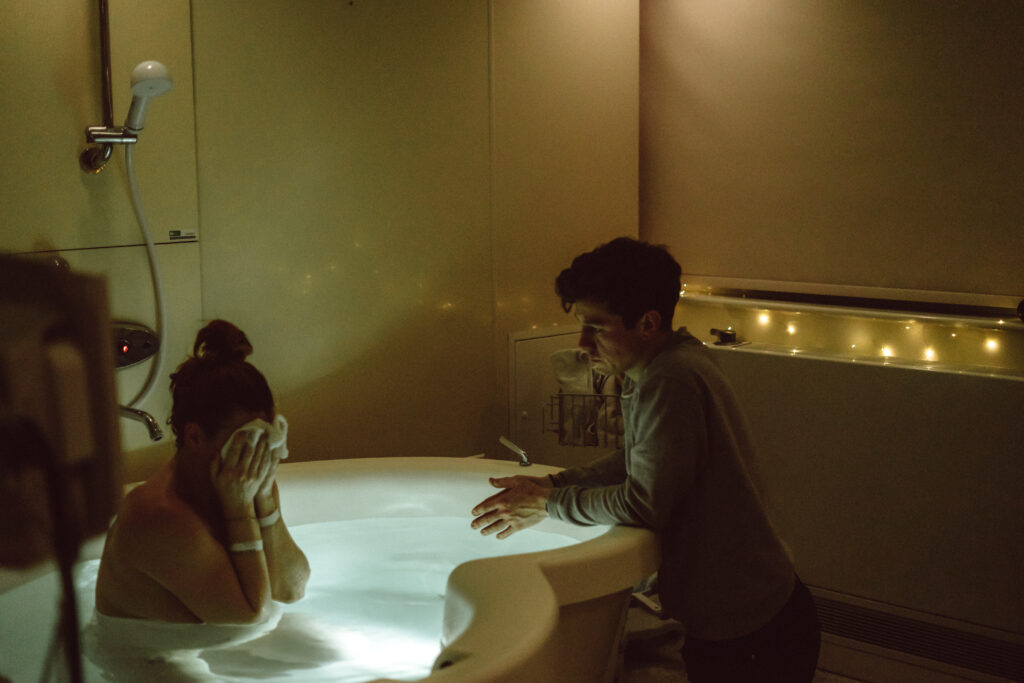 birth pool and birthing partner in pool at QEQM St Peters Midwife Led Unit taken by Kent birth photographer Naomi Gale