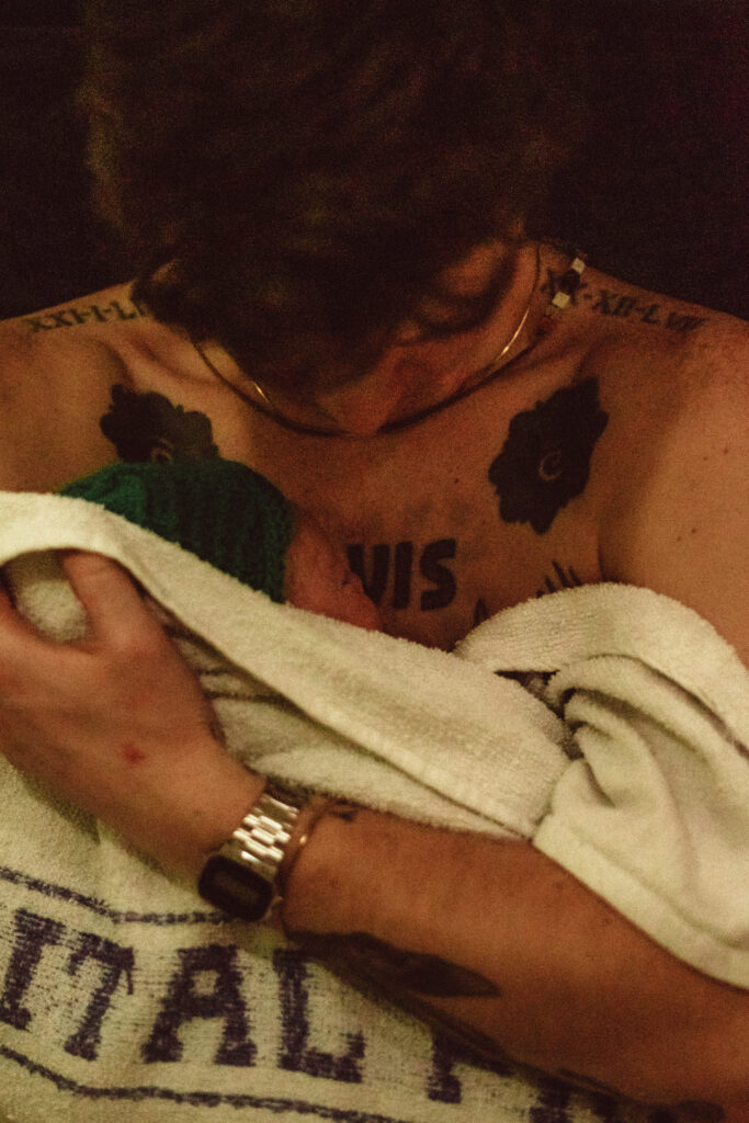 QEQM St Peters Midwife Led Unit Birth Pool with Margate Doula Support and Birth photographer Naomi Gale. Showing dad holding his baby for the first time.