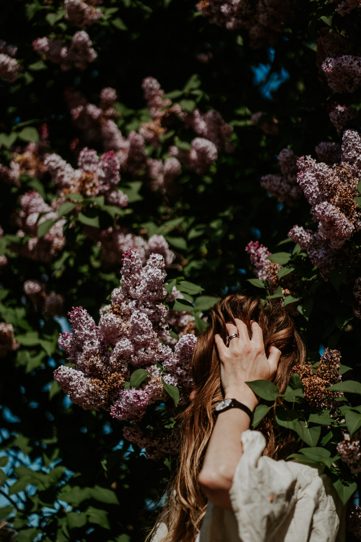 Naomi with eyes closed, surrounded by soft natural light, embodying rest and surrender in pelvic healing.