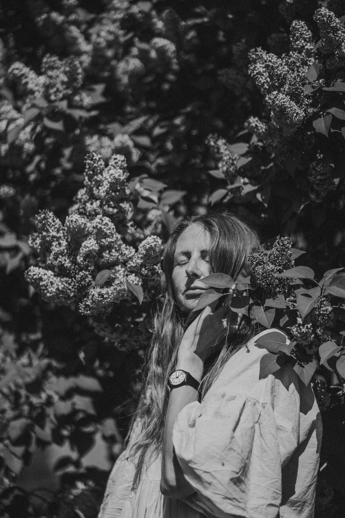 Naomi smiling gently in a leafy setting, symbolizing empowerment and sovereignty over one’s pelvic health journey.